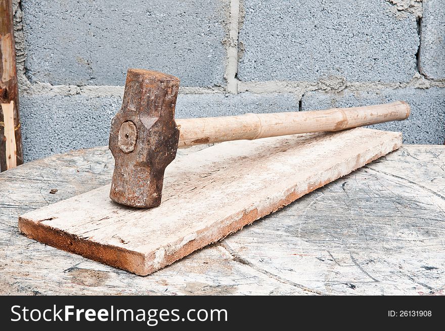 Old hammer on construction background