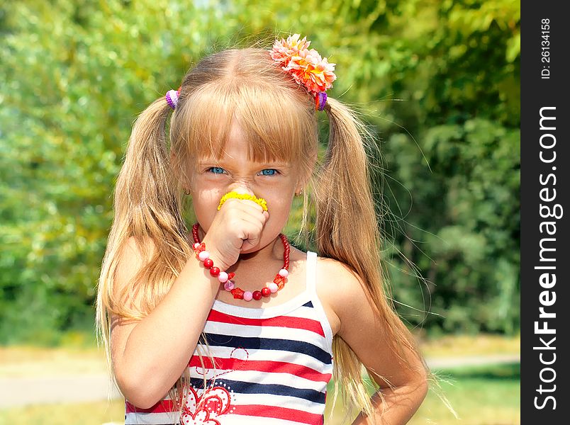 Little Girl Smelling Flower