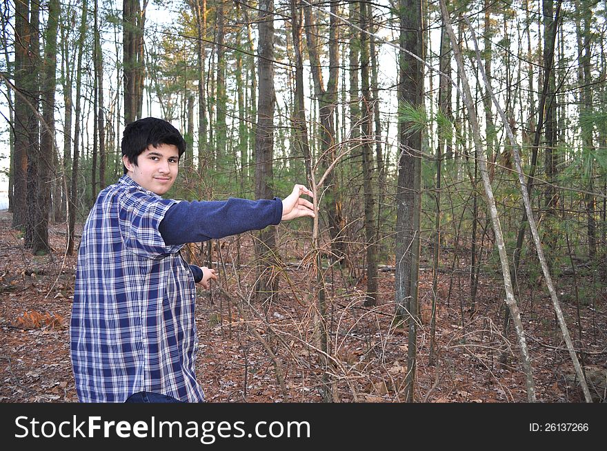 A teenager is exploring in a forest of Massachusetts. A teenager is exploring in a forest of Massachusetts.