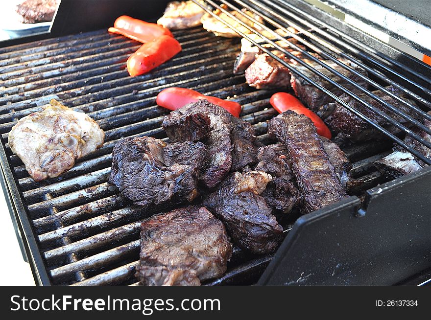 A barbecue with several types of meat. A barbecue with several types of meat