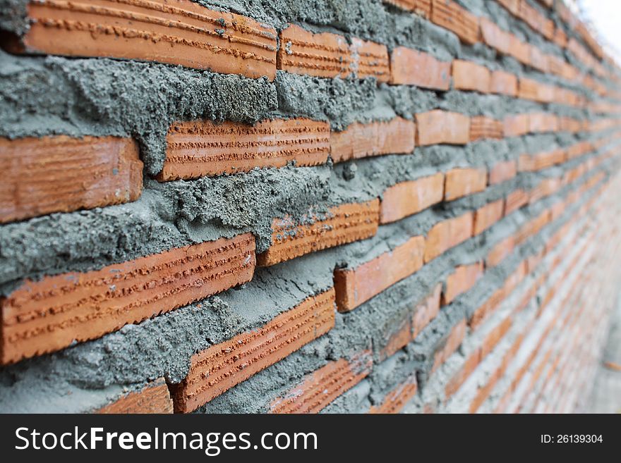 Close up of brick wall ending in infinity construction