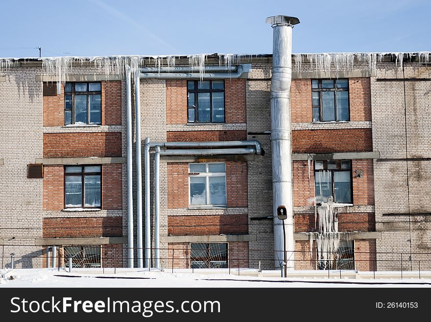 Industrial building with many icicles by cold winter day. Industrial building with many icicles by cold winter day