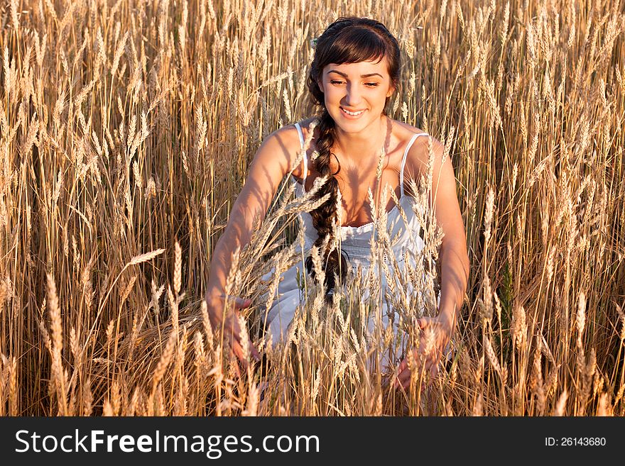 Woman in white dress in field with wheat
