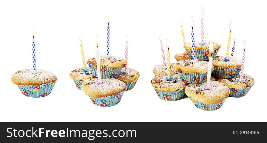 Holiday muffins with lit candles on white isolated background