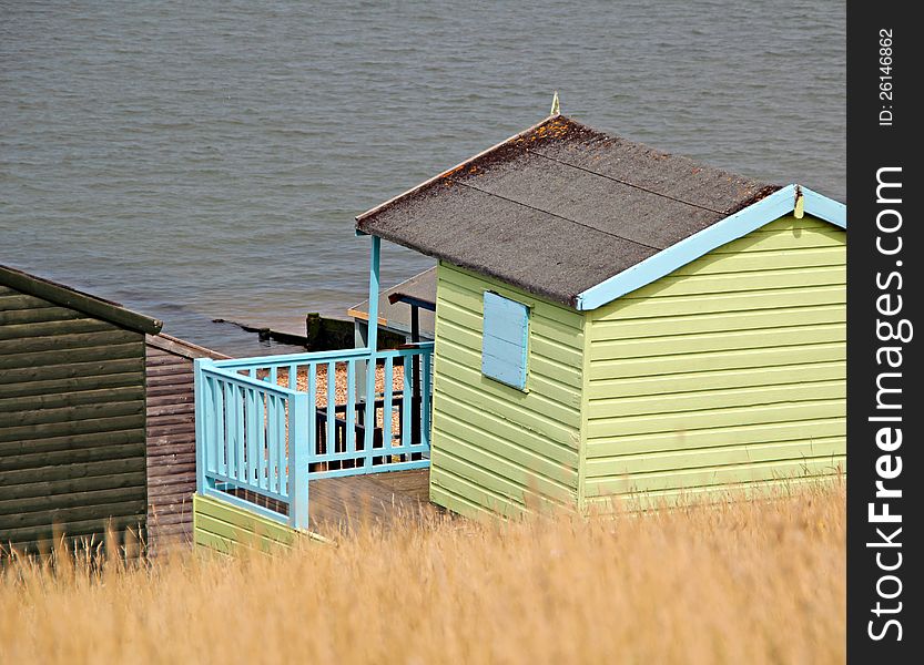 Photo of single wooden beach hut overlooking whitstable sea front. Photo of single wooden beach hut overlooking whitstable sea front.