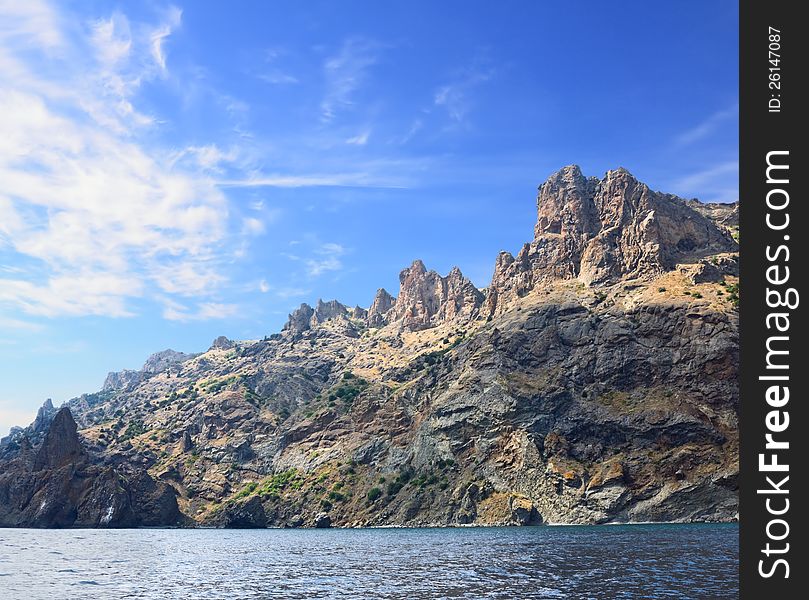 Rocks at sea against the blue sky