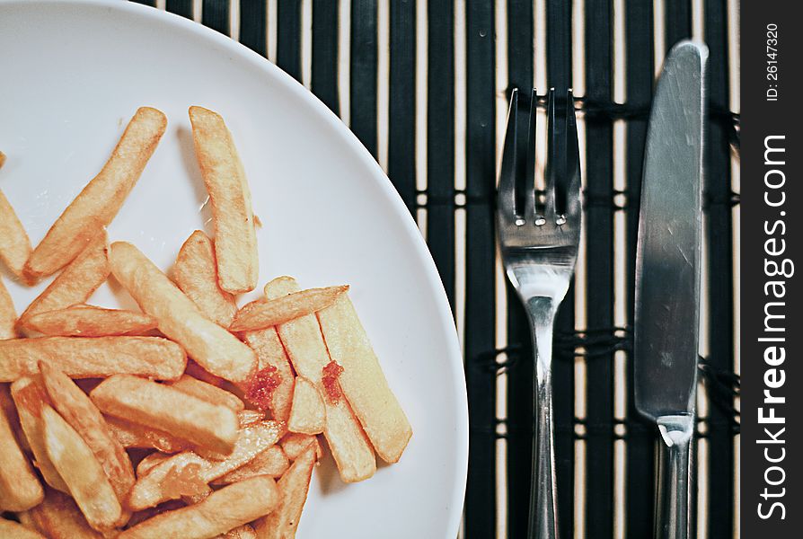 Breakfast with fried potatoes on a bamboo mat