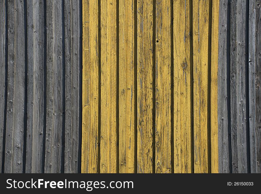Grunge wooden wall with some yellow paint