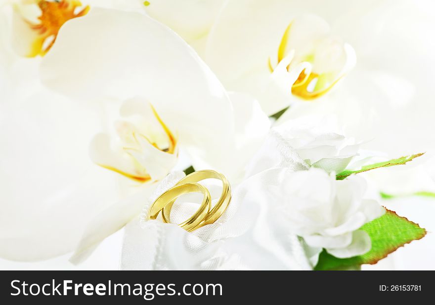 Close up on wedding bouquet (white orchid) and rings. Close up on wedding bouquet (white orchid) and rings