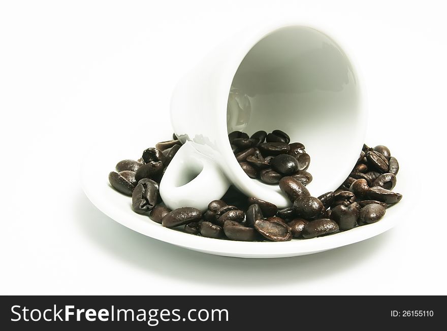 A coffee cup surrounded by coffee beans. A coffee cup surrounded by coffee beans