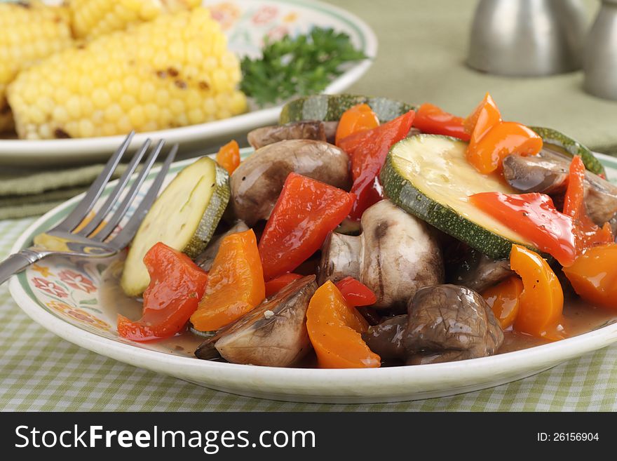 Fried vegetables with zucchini, peppers and mushrooms on a plate