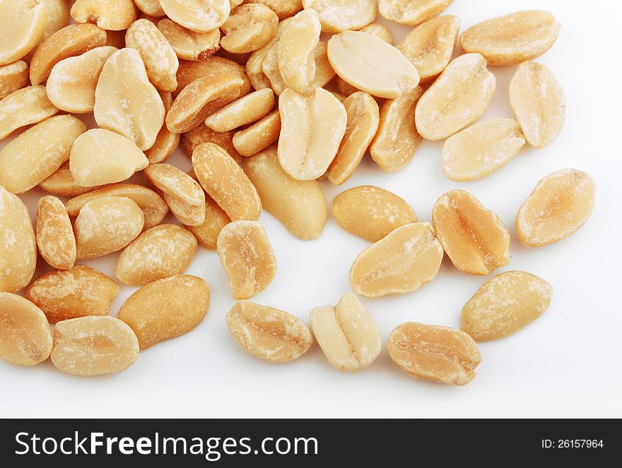 Closeup of salted peanuts on white background