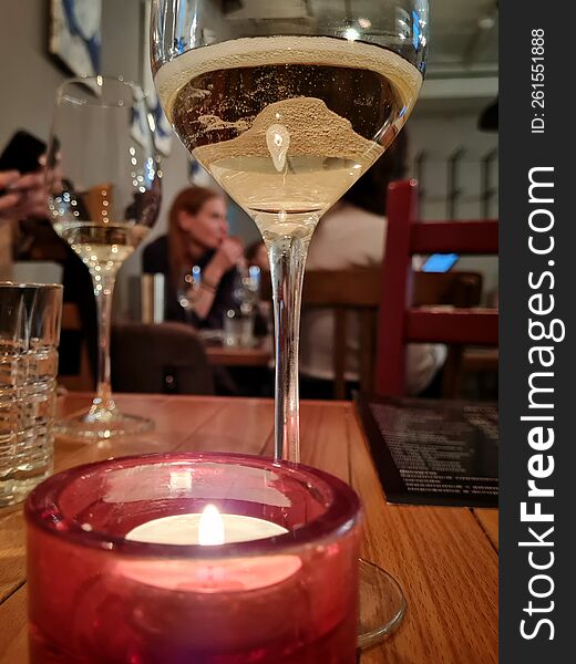 Glass Of White Sparkling Wine On The Table In Front Of Another Glass