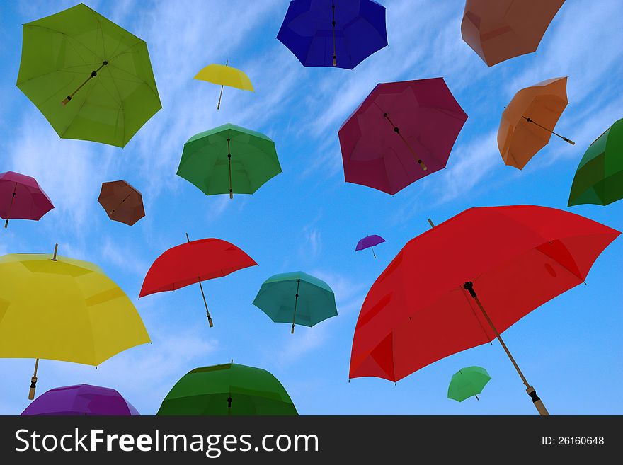 Flying of multicoloured umbrellas on a background blue sky with clouds