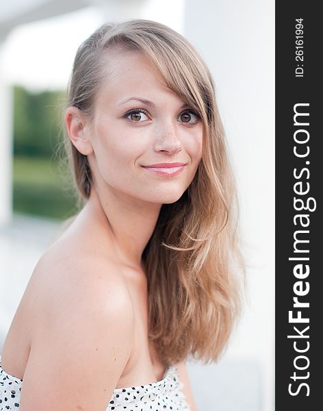 Portrait of young smiling girl in white dress outdoor. Portrait of young smiling girl in white dress outdoor