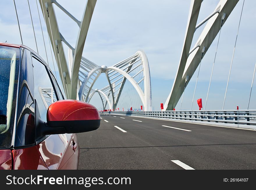 A car runs over the bridge. A car runs over the bridge