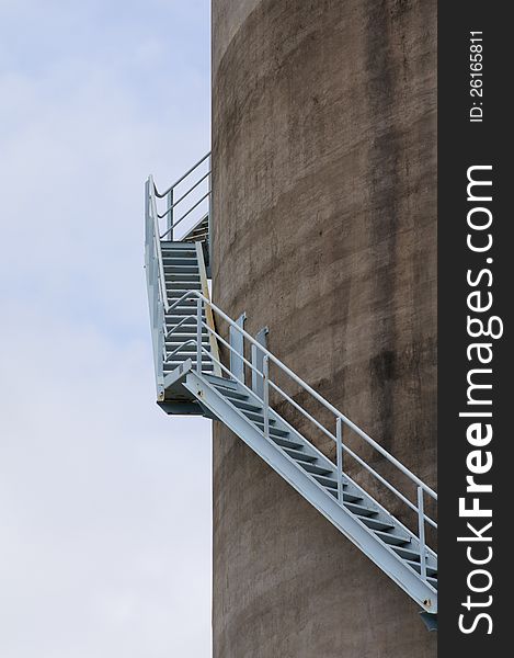 Wrap-around stairs leading up the side of a concrete silo. Wrap-around stairs leading up the side of a concrete silo.