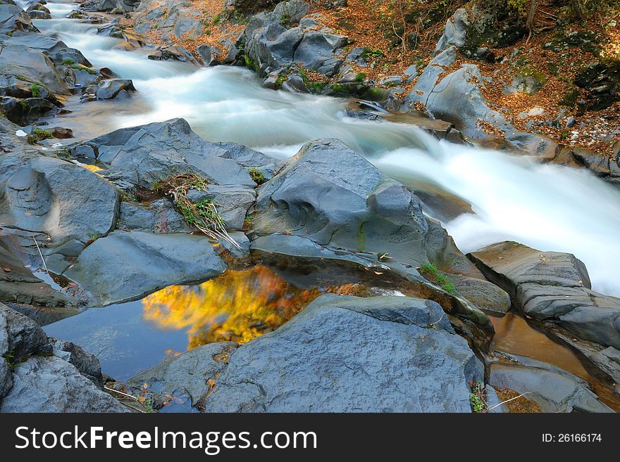 Mountain river among autumnal forest. Mountain river among autumnal forest