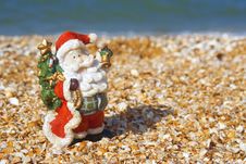 Toy Santa Claus At The Beach Stock Image