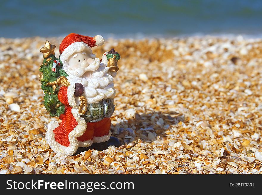 Toy Santa Claus at the beach