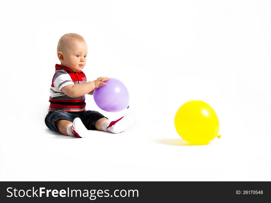 Child sit with balloons sit on the floor. Child sit with balloons sit on the floor