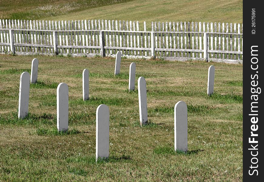 Old Cemetery White Headstones In A Field.