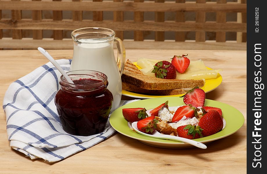 Village Breakfast of Toasts, Strawberries, Jam, Milk and Curds close up on wooden background. Village Breakfast of Toasts, Strawberries, Jam, Milk and Curds close up on wooden background