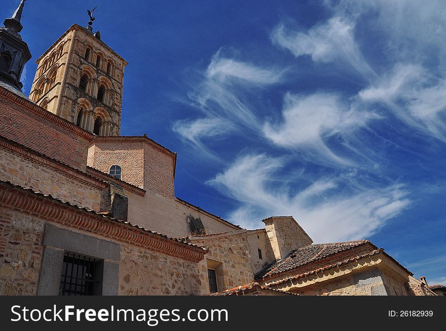 San Martin Church in Segovia, Castile, Spain. Blue sky and white cirrus clouds. San Martin Church in Segovia, Castile, Spain. Blue sky and white cirrus clouds