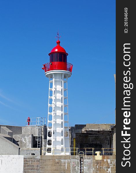 Lighthouse in red and white with a blue sky