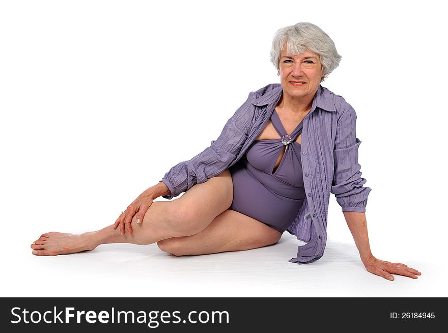 Attractive Senior Citizen Lady wearing a swimming suit on a white background