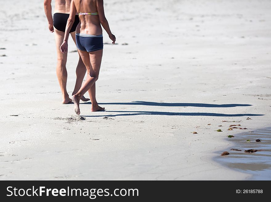 Couple walks along the beach