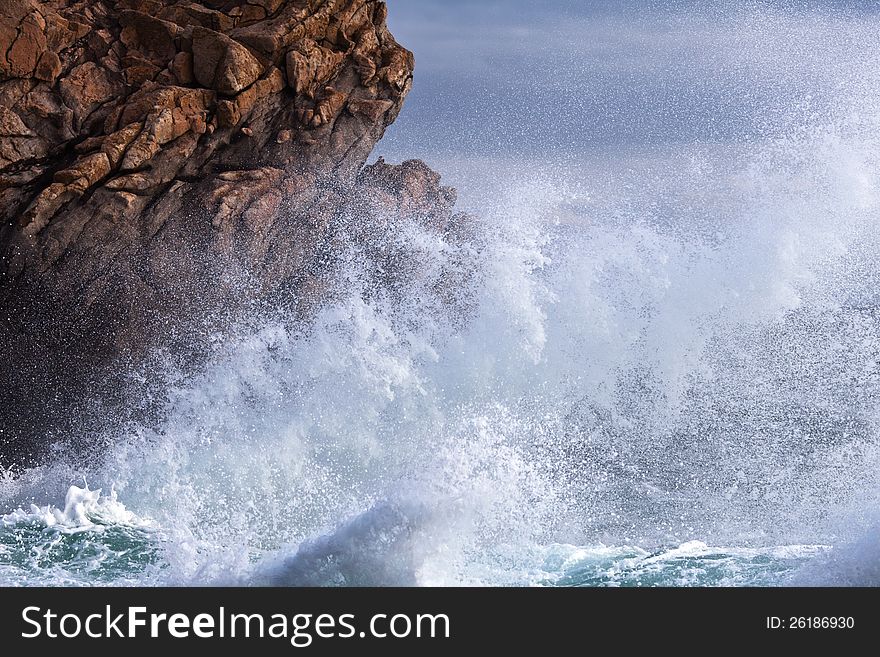 Waves crashes against the rocks of the Breton coast in France. Waves crashes against the rocks of the Breton coast in France