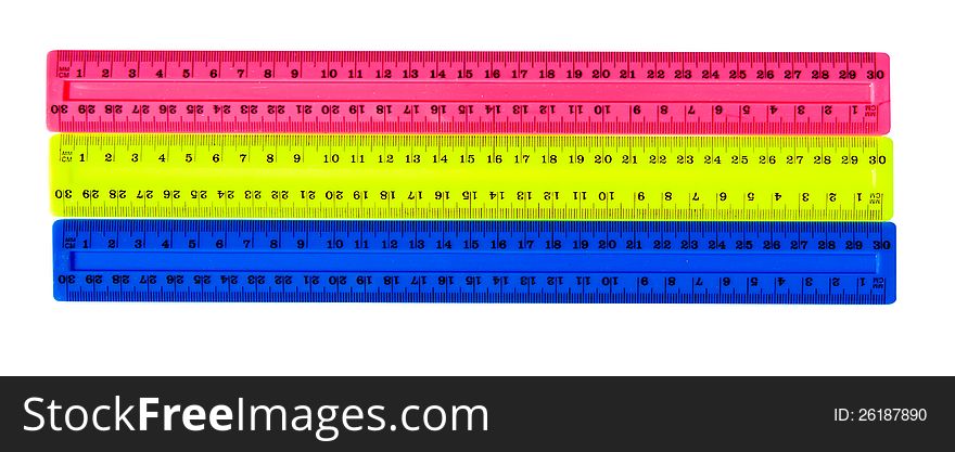 Three color plastic rulers isolated on white