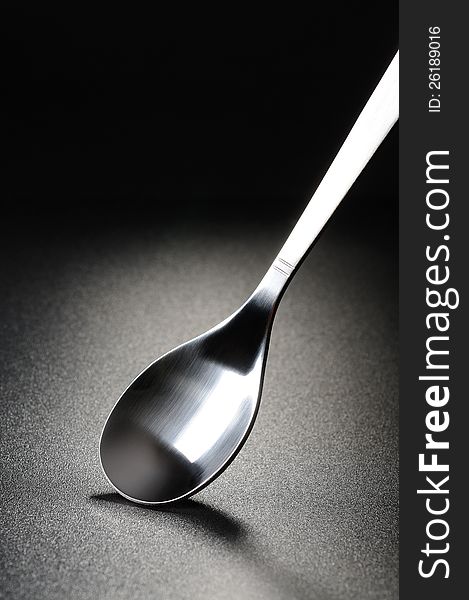 Steel Teaspoon on a black matte background