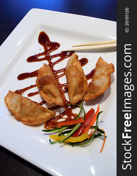 Fried Japanese gyoza dumplings artfully arranged on a plate