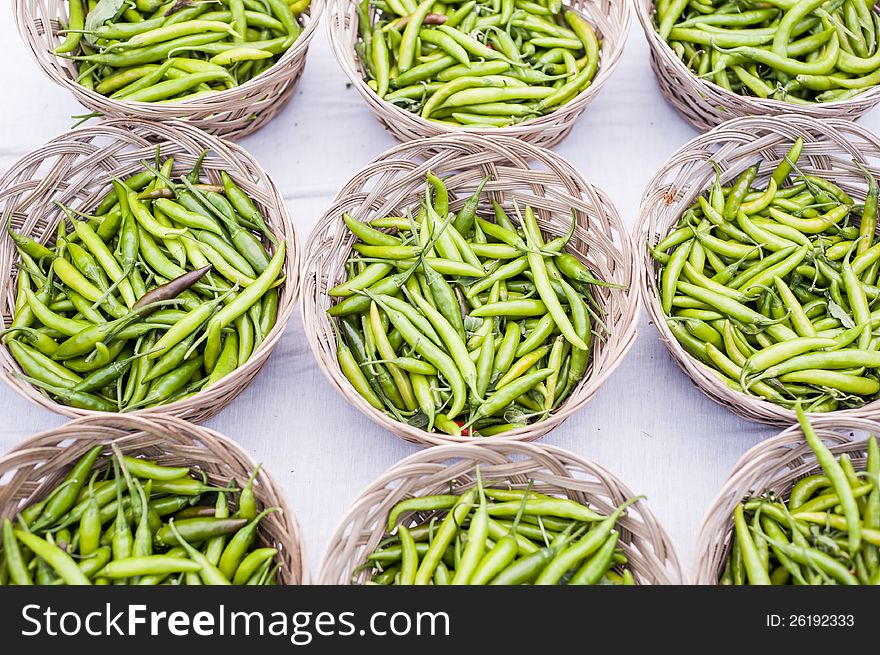 Fresh, green hot peppers organized into baskets. Fresh, green hot peppers organized into baskets.