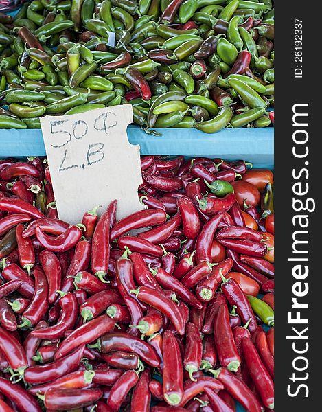 Fresh, green and red hot peppers for sale at local farmers market. Fresh, green and red hot peppers for sale at local farmers market.