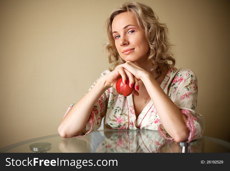 The Girl with apple sitting at the table