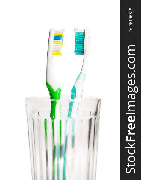 Closeup Toothbrushes in transparent glass. Isolated of background