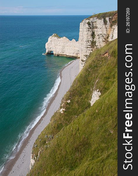 Top view of a cliff in Etretat, France in Normandy with its pebble beach. Top view of a cliff in Etretat, France in Normandy with its pebble beach