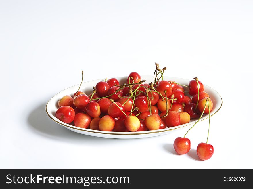 Dish of cherries over white