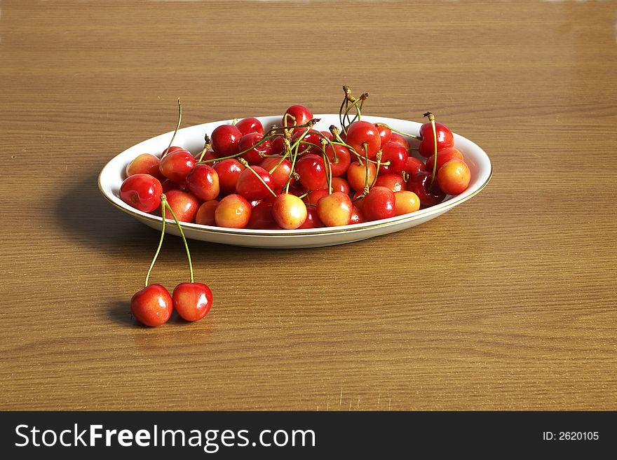 Dish of cherries over wood