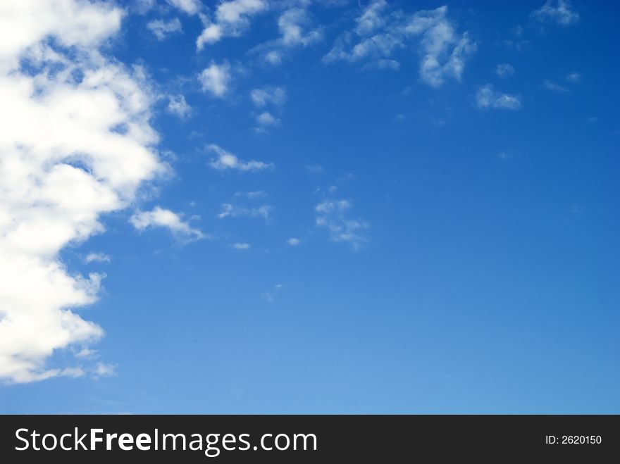Clouds with a very blue saturated sky. Composition leaves a lot of space for text.