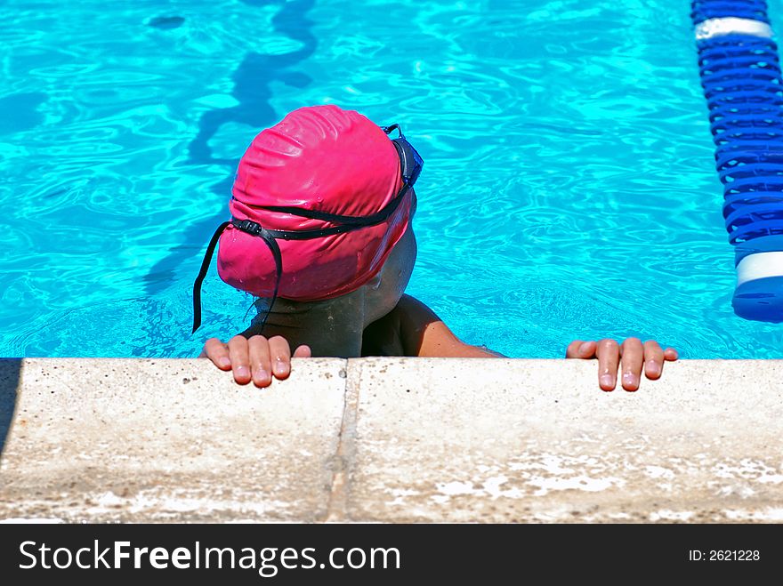 Young girl looking to see what her time was in the 100 yard breast stroke event. Young girl looking to see what her time was in the 100 yard breast stroke event.