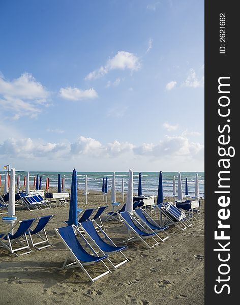 Umbellas and seats in a private beach of tuscany. Umbellas and seats in a private beach of tuscany