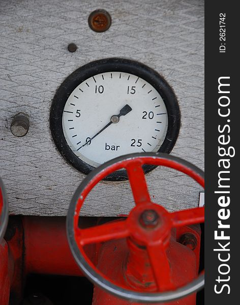 Pressure gauge and red metal handle. Pressure gauge and red metal handle