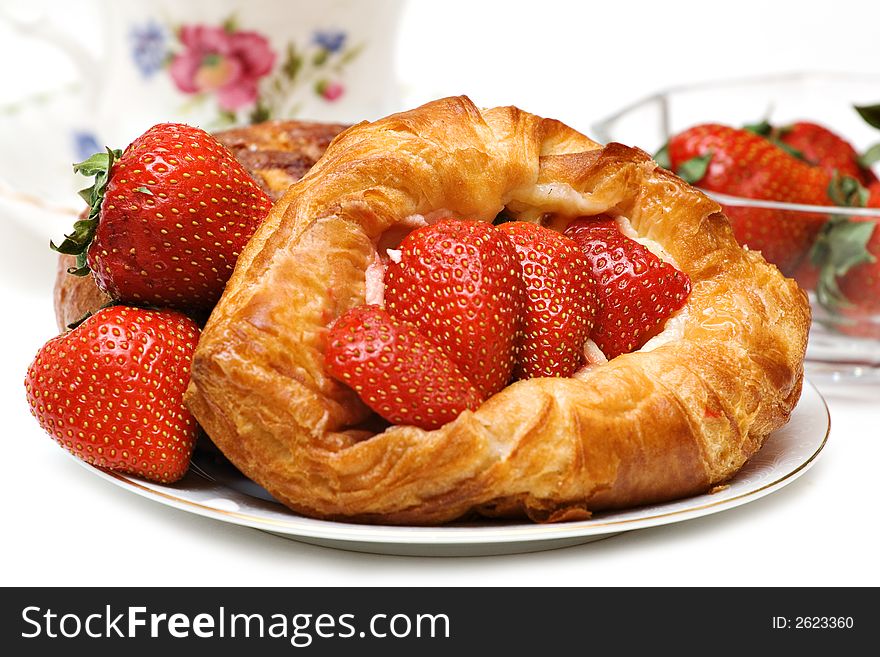 Beautiful Strawberry pastry with fresh fruit and a cup of tea. Beautiful Strawberry pastry with fresh fruit and a cup of tea.