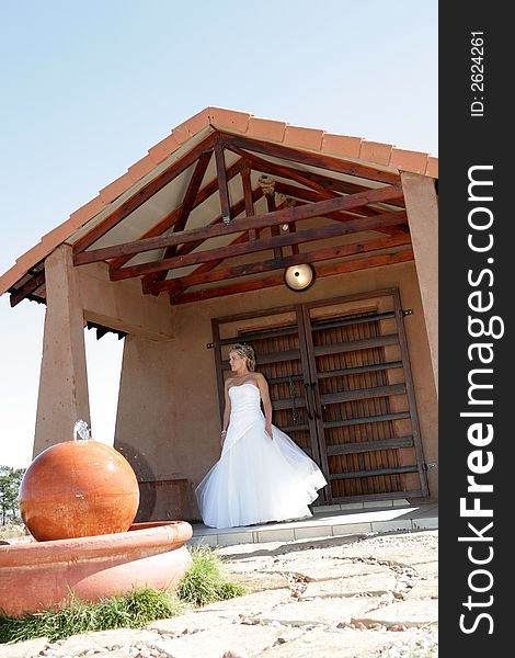 A bride standing on a porch in her dress. A bride standing on a porch in her dress