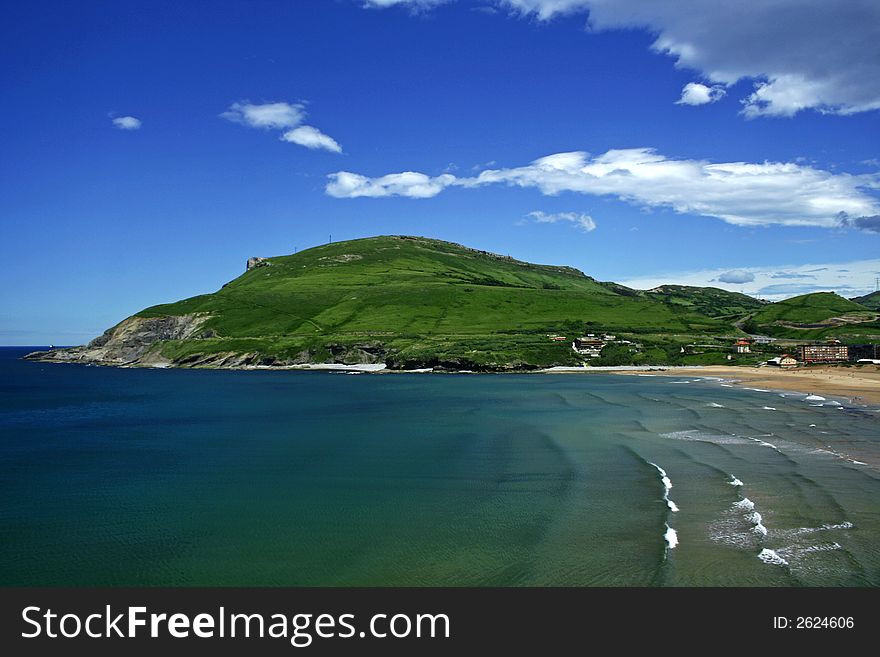A seascape of a beautiful beach and a hill. A seascape of a beautiful beach and a hill.