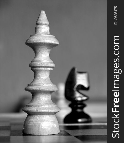 A game of chess with the focus on the white king.